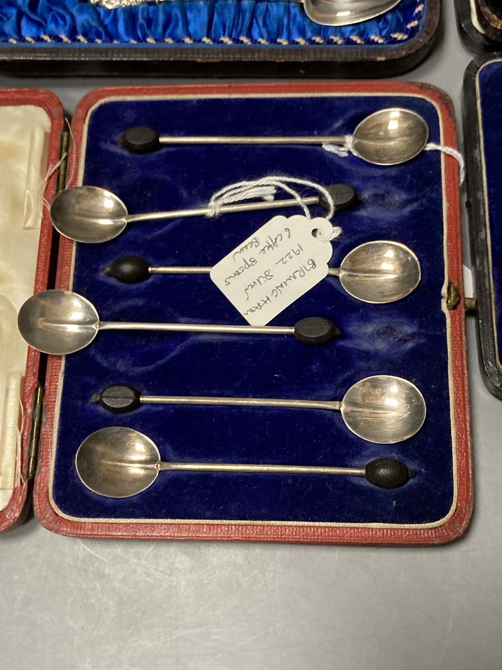 Twelve Victorian silver Apostle coffee spoons and sugar tongs, and three sets of six silver bean end coffee spoons, all cased